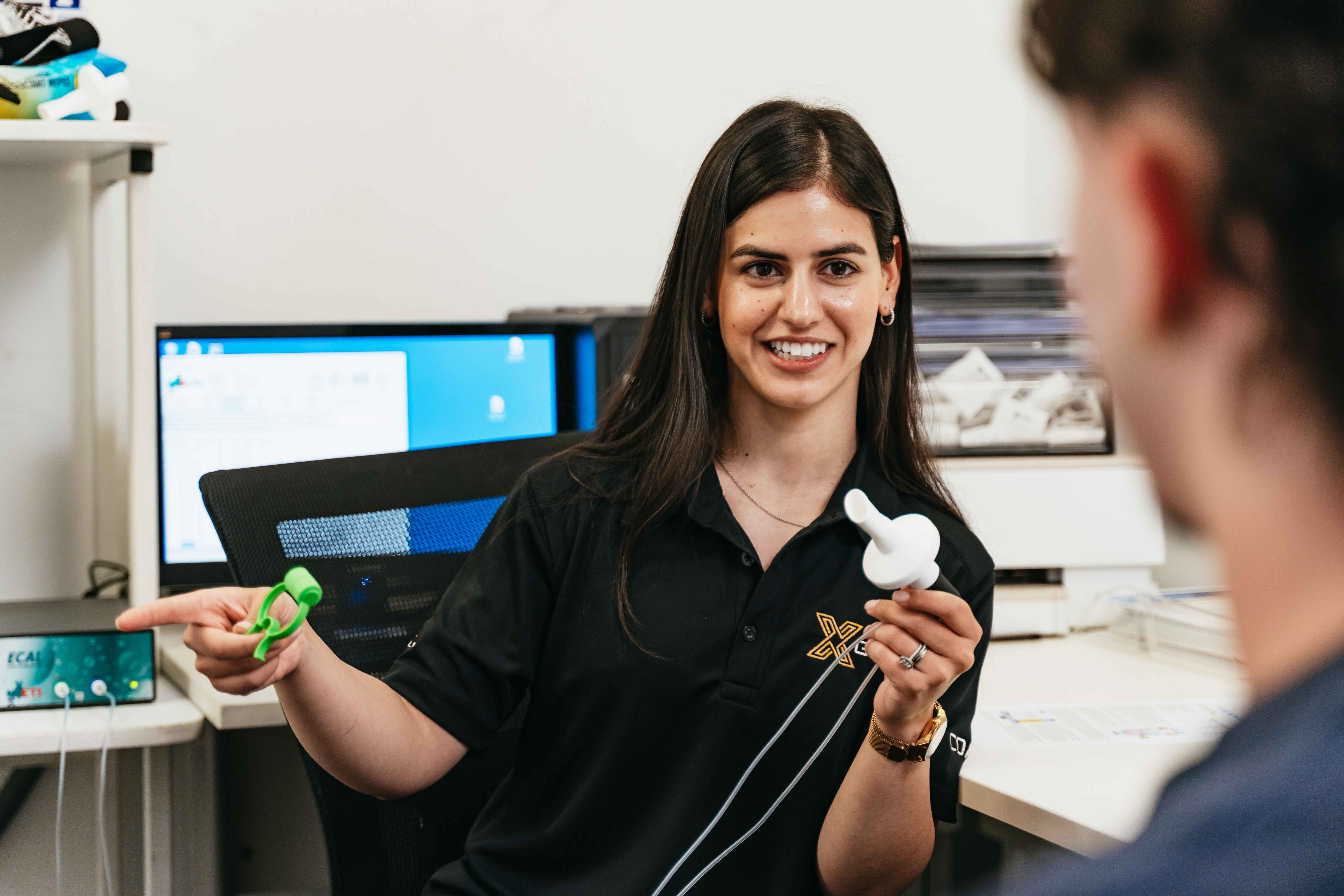 Clinician explaining RMR test equipment to client